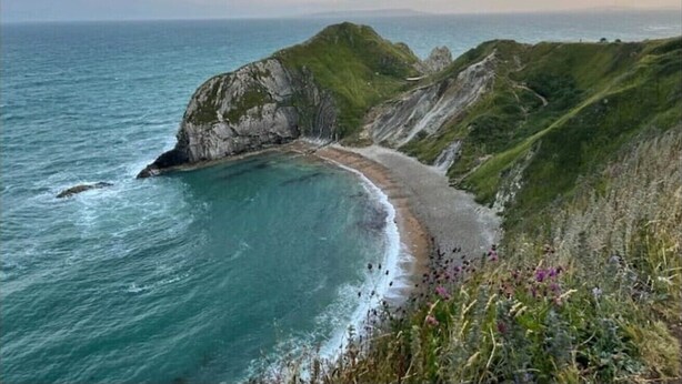 A coastal landscape with a winding road along the cliffs and a beach. - Private Pool, Hot Tub, Luxury Cabana Poole Dorset. (Poole)