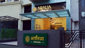 A hotel entrance with a sign reading "ARALIA A Business Hotel" and a logo above the entrance. - Aralia - A Business Hotel MIDC (Mumbai)