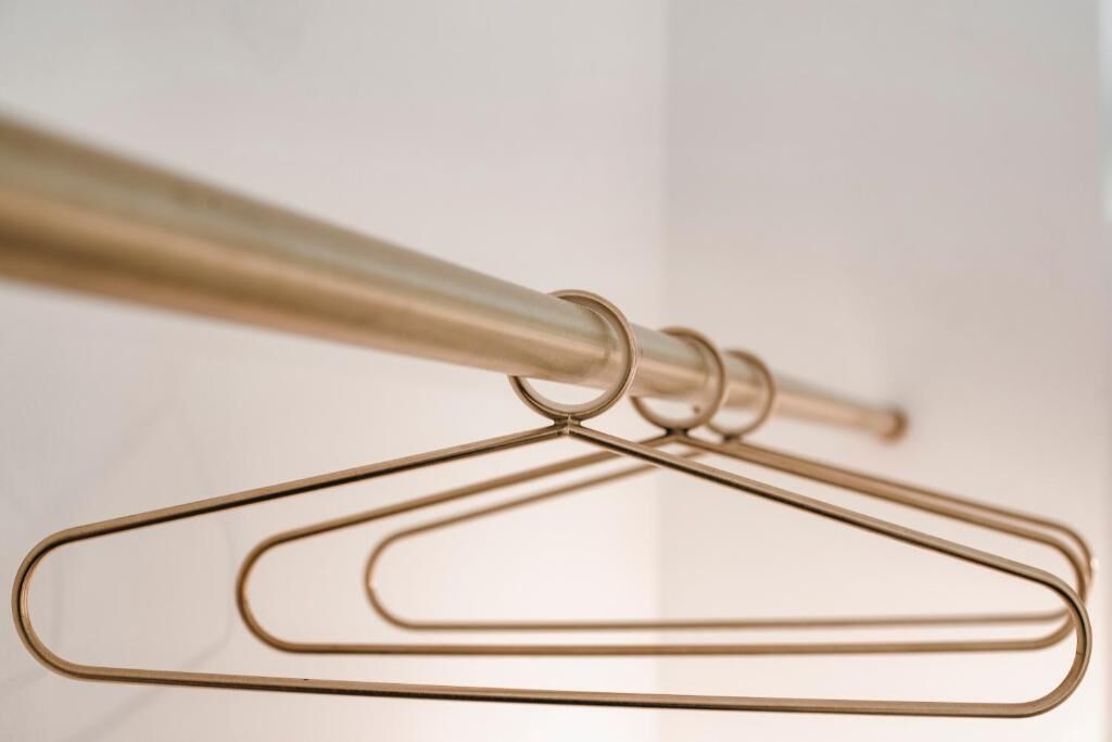 A close-up of a metal hanger with a circular ring, likely part of a hanging system.