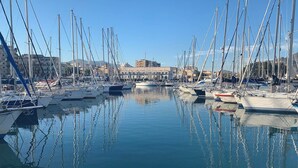 A marina with multiple sailboats docked, calm water, and buildings in the background. - Terrace In The Historic Center In Palermo Pino (Palermo)