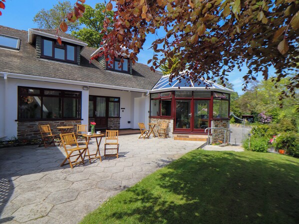 A house with a patio, stone walls, and a conservatory. - Lakeside (Falmouth)