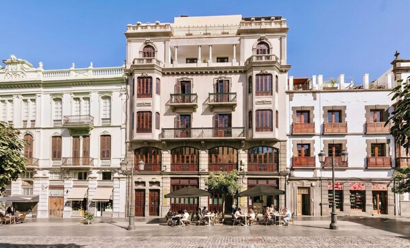 A historic building with multiple balconies, a central courtyard with outdoor seating, and a traditional European architectural style. -  MASANET Emblematic Hotels by Airnest (Las Palmas de Gran Canaria)