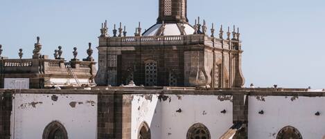 A historical building with a prominent dome and arched windows.