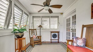 A room with a ceiling fan, wooden furniture, a potted plant, and a view through large windows. - Fort Lauderdale Oasis w/ Pool ~ 2 Mi to Beach! (Fort Lauderdale)