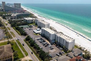 A coastal hotel with a parking lot, beach access, and ocean views. - Beach House 505b 1 Bedroom Condo by RedAwning (Miramar Beach)