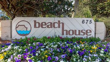 A beach house sign with a water icon and the number 675.