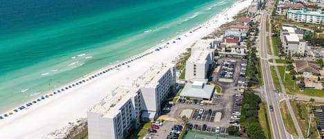A coastal hotel with a beach view, parking, and tennis courts.
