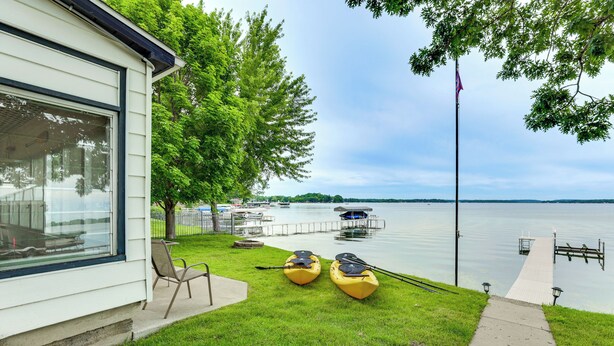 A lakeside property with a dock, kayaks, and a flagpole. - Lakefront Getaway w/ Several Extra Amenities (McFarland)