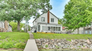 A house with a porch, a dock, and a small pond. - Lakefront Getaway w/ Several Extra Amenities (McFarland)