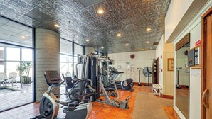 A gym with various exercise machines, a bench, and a fan. - Steps to Slopes! Mtn-view Sugar Top Condo w/ Pool (Banner Elk)
