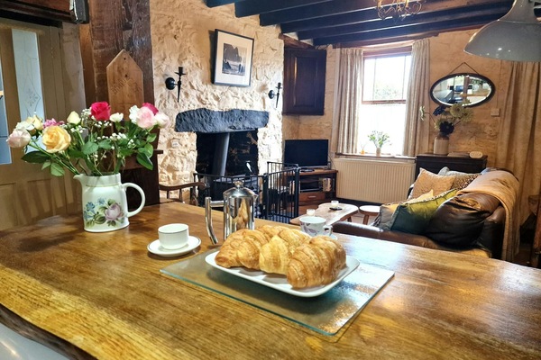 Kitchen worktop with coffee pot, coffee cups and plate of croissants