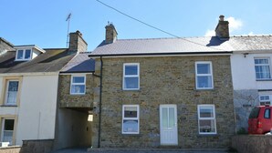 A stone building with a white door and multiple windows. - Arwel, Aberporth - Three Bedroom Cottage, Sleeps 6 (Aberporth)