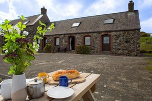 Enjoy a casual dining experience in this charming stone building with a fireplace and scenic views.