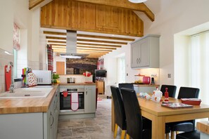Enjoy cooking in this well-equipped kitchen with a central island, oven, and microwave.