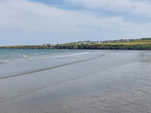 Enjoy the serene beach views and gentle waves lapping at the shore.