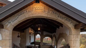 A stone archway with inscriptions and a wooden gate leading to a building. - San Vinogradara - One Bedroom Holiday Home With Hot Tube (Donja Stubica)