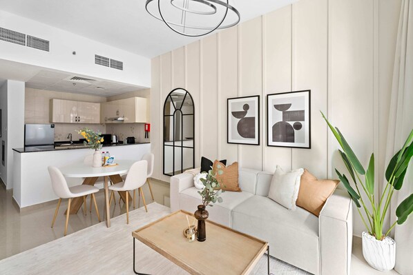 Elite Apartment, Balcony, City View | Living area | 50-inch TV with cable channels