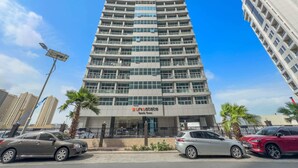 A multi-story hotel with a modern design, featuring a prominent entrance and a visible name sign. - Silkhaus Uniestate Sports Tower - DSC (Dubai)