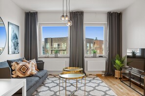 Deluxe Apartment | Living area | 40-inch Smart TV with digital channels