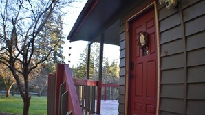 A wooden deck with a red door and a mailbox. - Wild Orchards in the Camas Hills (Camas)