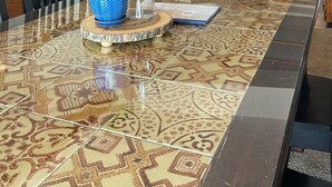 A dining area with a patterned tile floor, a glass-top table, and a blue decorative bowl. - Wild Orchards in the Camas Hills (Camas)