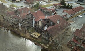 A residential area with multiple houses, a parking lot, and a body of water. - Rivers Edge 803B (Helen)