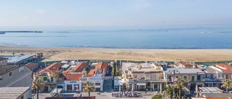 A coastal town with buildings, a beach, and the sea.