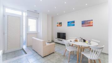 Apartment, City View | Living area | 32-inch flat-screen TV with satellite channels