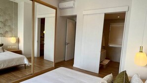 A bedroom with a large mirror, a bed, a wardrobe, and a walk-in closet. - Breathtaking seaview penthouse (Belle Mare)