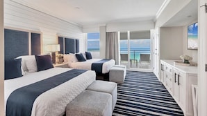A hotel room with two beds, a balcony with a view of the ocean, and a white dresser. - 2/2 Beachfront, VIEWS, Pool, Private Beach Access (Longboat Key)