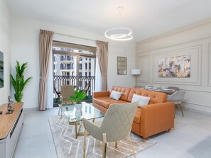 Apartamento com design assinado, 1 cama King e sofá-cama, sacada, vista para o pátio | Área de estar | Smart TV 55 polegadas com canais digitais, Netflix