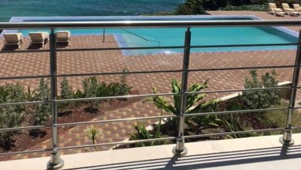 A pool with a view of the ocean and mountains in the background. - Luxury Suite 2.4 in Seneca, Point Blanche, St Maarten (Point Blanche)