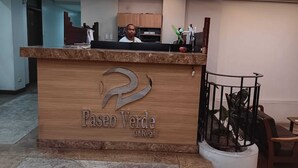 A reception desk with a logo and the name 'Paseo Verde at Real'. - Paseo Verde Condominium (Las Pinas)