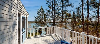 Dog-friendly river-view home with wood stove, deck, patio, dock, beach, grill