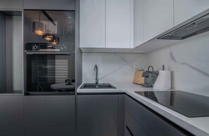 A modern kitchen with a Bosch microwave, a sink, and a coffee machine.