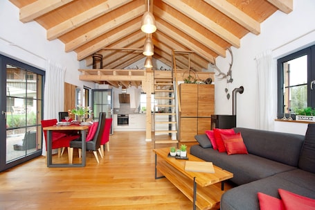 TV, fireplace. Holiday Home 'Schorenmoos Lodge' with Private Terrace, Private Garden and Wi-Fi