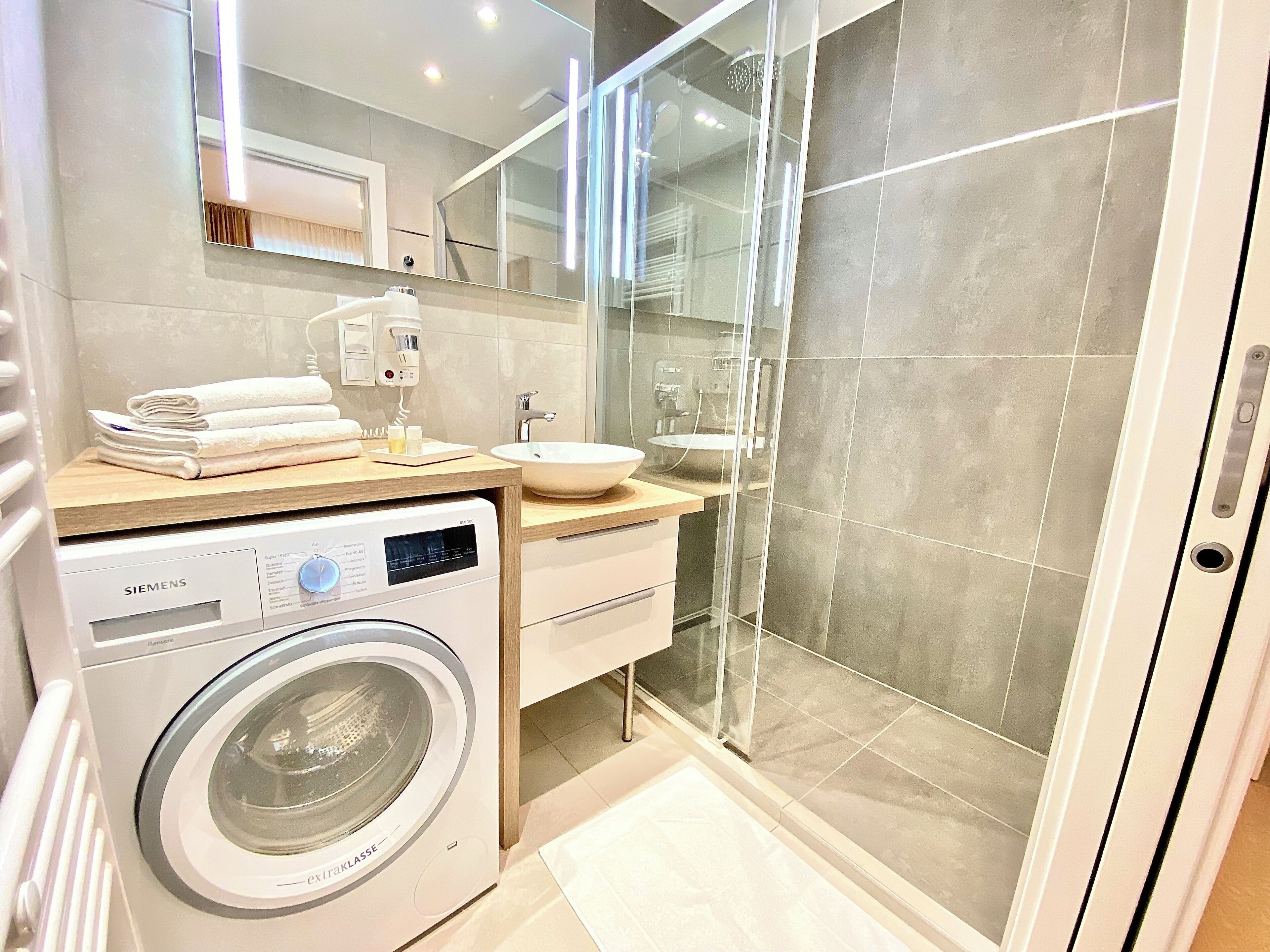 Shower, hair dryer, heated floors, towels
