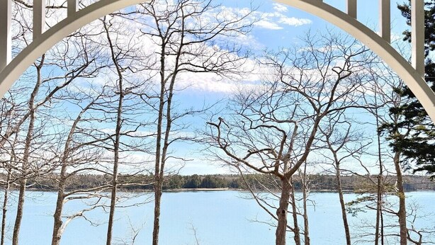 A covered porch with a view of a lake and trees. - Mere Point Sunrise Views at Eastern Shore! (Brunswick)