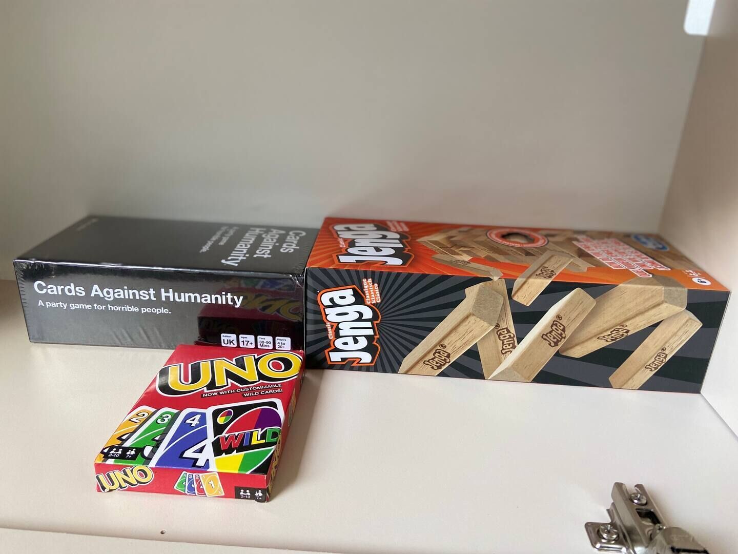 Three boxes of UNO cards, one of which is labeled "Cards Against Humanity."