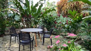 A stone patio with a round table and four chairs. - 2 bedrooms with pool. Walking distance to Cabarete beach, restaurants, shops. (Cabarete)