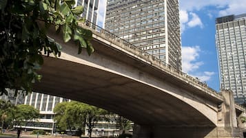 Eine Betonbrücke über einer Straße, im Hintergrund hohe Gebäude.
