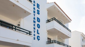 A multi-story building with balconies and a sign reading "APRES DOLCE APARTMENTS".