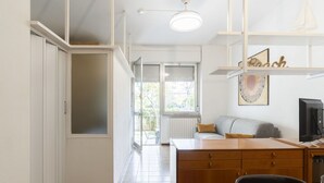 A modern kitchen with a dining area, a built-in oven, and a window with a view of the outside. - Nice apartment for 4 guests with A/C, WIFI, terrace and pets allowed (Marina Di Andora)