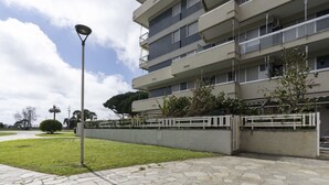 A multi-story residential building with balconies, a paved walkway, and a street lamp. - Nice apartment for 4 guests with A/C, WIFI, terrace and pets allowed (Marina Di Andora)