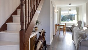 Un escalier menant à un salon avec vue sur l’extérieur.
