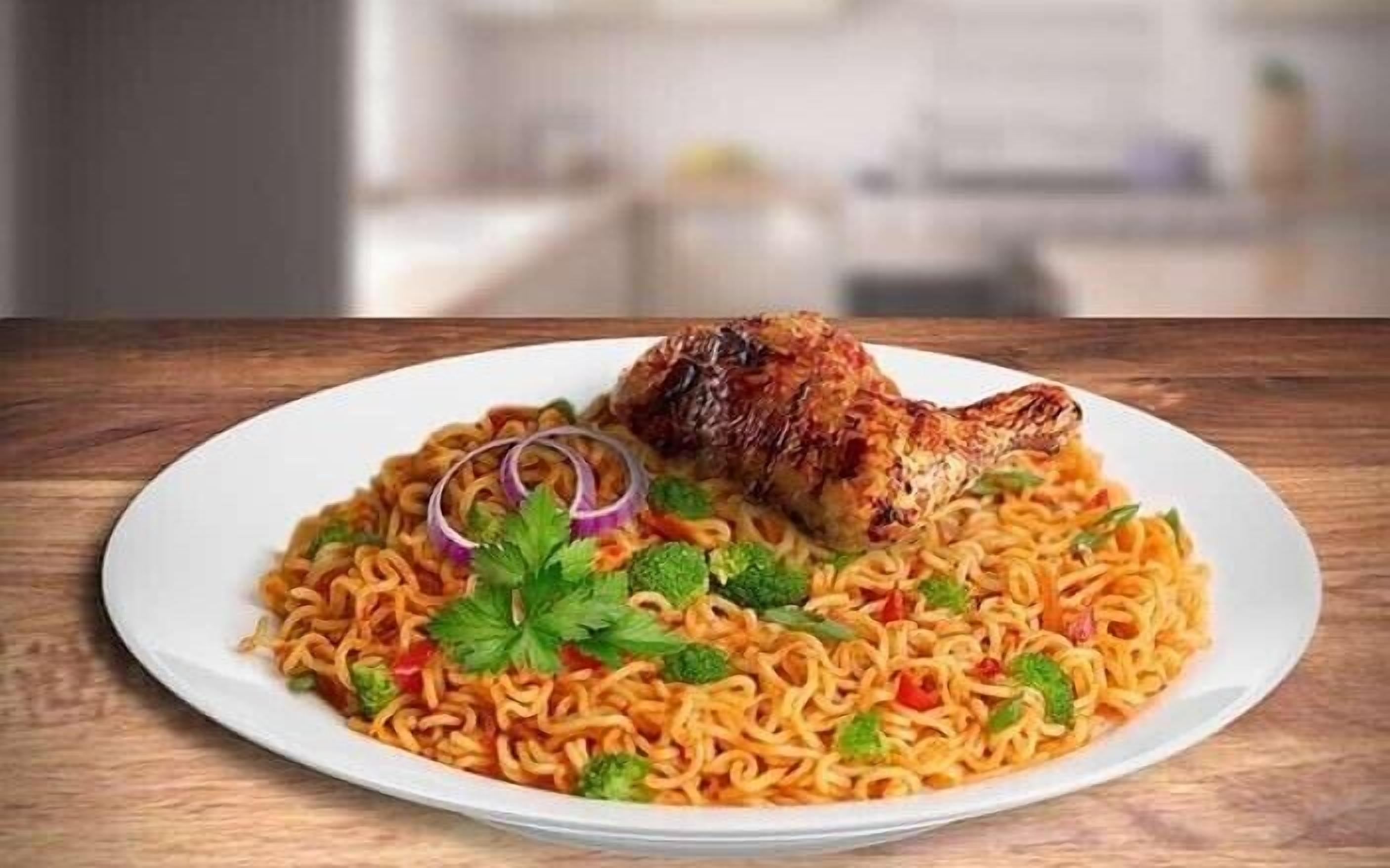 A plate of noodles with a piece of grilled chicken on top, garnished with red onion and cilantro.