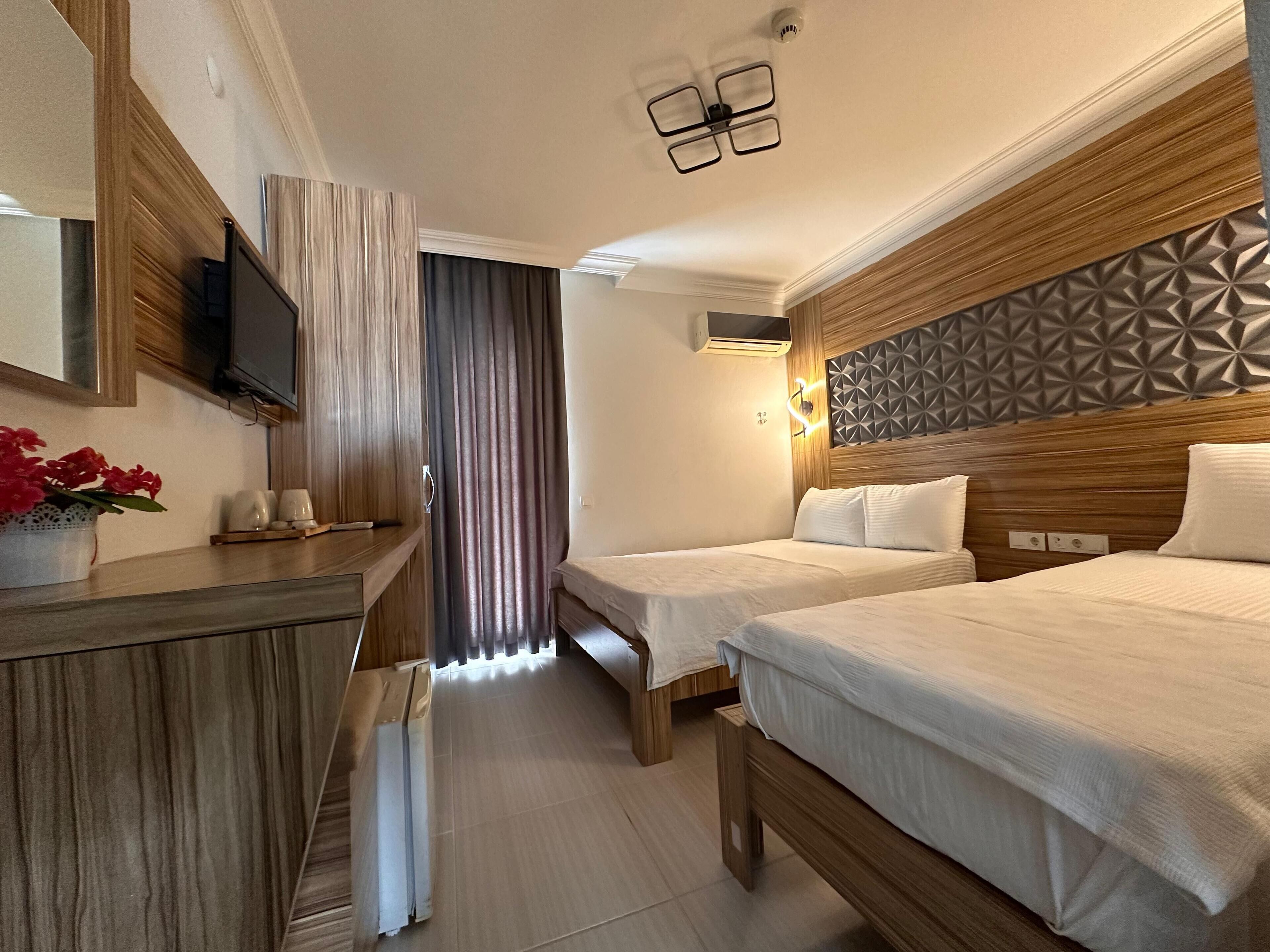 Family Triple Room, Balcony | Premium bedding, minibar, desk, laptop workspace
