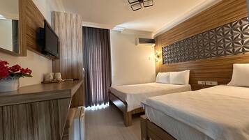 Family Triple Room, Balcony | Premium bedding, minibar, desk, laptop workspace