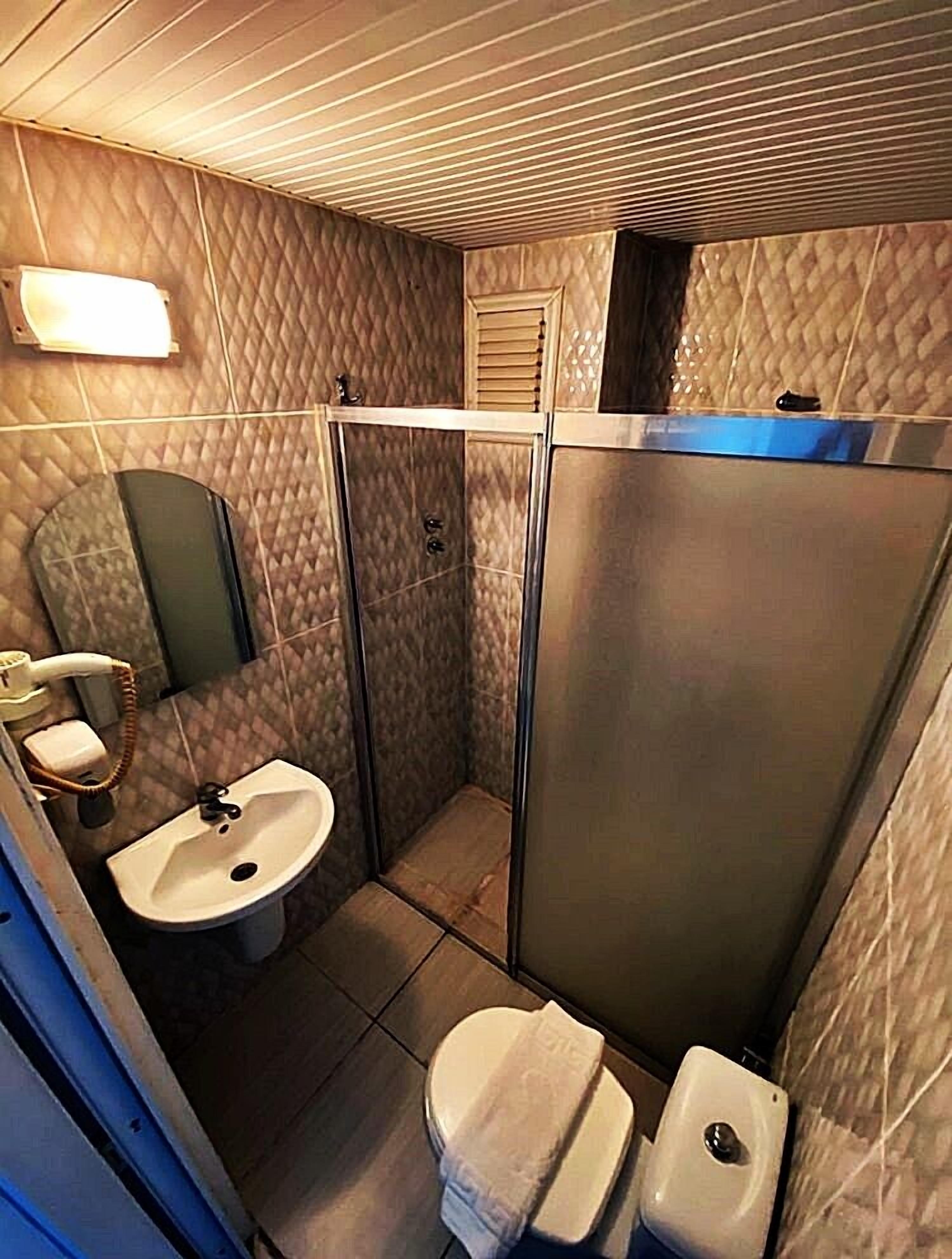 Shower, hair dryer, slippers, towels