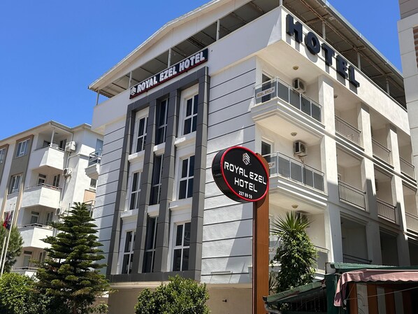 A hotel building with balconies and a sign indicating it is the Royal Ezel Hotel. - Royal Ezel Hotel (Antalya)